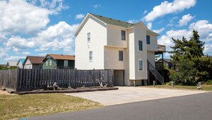 A two-story house with a front yard and a wooden fence. - Oceanside, Private Pool, Close to Beach Access and Shopping! KH1, Marabel-by-the-Sea (Kitty Hawk)
