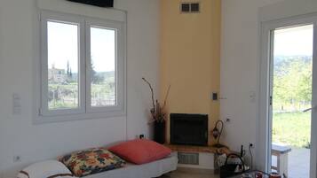 Villa | Living area | Flat-screen TV, fireplace