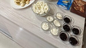 A buffet table with various food items and condiments. - Orion Hotel (Tashkent)