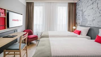 A hotel room with two beds, a desk, a chair, and a TV displaying the Intercity Hotel logo.