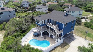 A multi-story house with a swimming pool, multiple balconies, and a covered patio area. - Semi-Oceanfront, Private Pool, Poolside Bar, Hot Tub, Ocean Views! T1, Sailaway (Kitty Hawk)