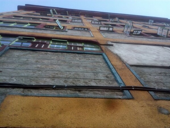 A building with multiple windows and a central corridor.