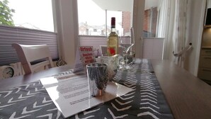 A dining table with a menu, a bottle of wine, and a glass. - Nordmarkhof (Sylt)