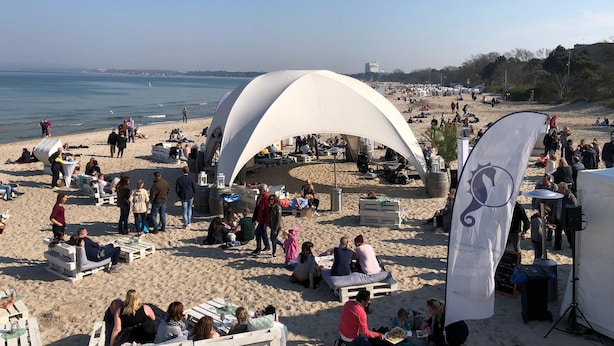 A beach with white tents and tables set up for an event. - Schoenhier-timmendorf (Timmendorfer Strand)