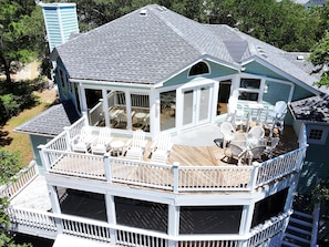 A multi-level house with a deck, outdoor seating, and a covered patio area. - Soundfront, Sound views, Private Pool, Hot Tub, MS12, Sounds Amazing (Corolla)