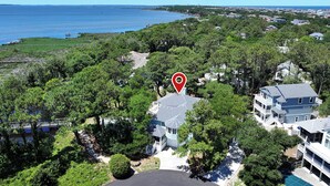 A residential area with a large house featuring a two-story structure, a swimming pool, and a view of the ocean. - Soundfront, Sound views, Private Pool, Hot Tub, MS12, Sounds Amazing (Corolla)