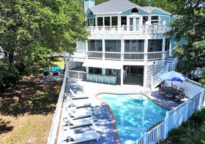 A multi-story house with a swimming pool, deck chairs, and a covered outdoor area. - Soundfront, Sound views, Private Pool, Hot Tub, MS12, Sounds Amazing (Corolla)