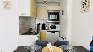 A compact kitchen with a sink, stove, microwave, and a small refrigerator. - PORT AN DRO - Studio in holiday rental in Carnac - UD98 (Carnac)