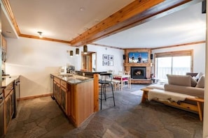 Cozy living area with a fireplace, comfortable sofa, and dining table.