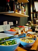 A buffet with various dishes labeled, including 'Crown salad' and 'Olivenost'.
