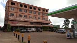 Un immeuble à plusieurs étages, sur lequel on peut voir des enseignes indiquant « Dillons Supermarket » et « Highway Motel ».