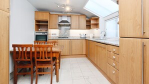 Design Penthouse | Private kitchen | Full-size fridge, microwave, oven, stovetop