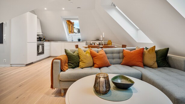 A modern loft apartment with a kitchen, dining area, and living room.