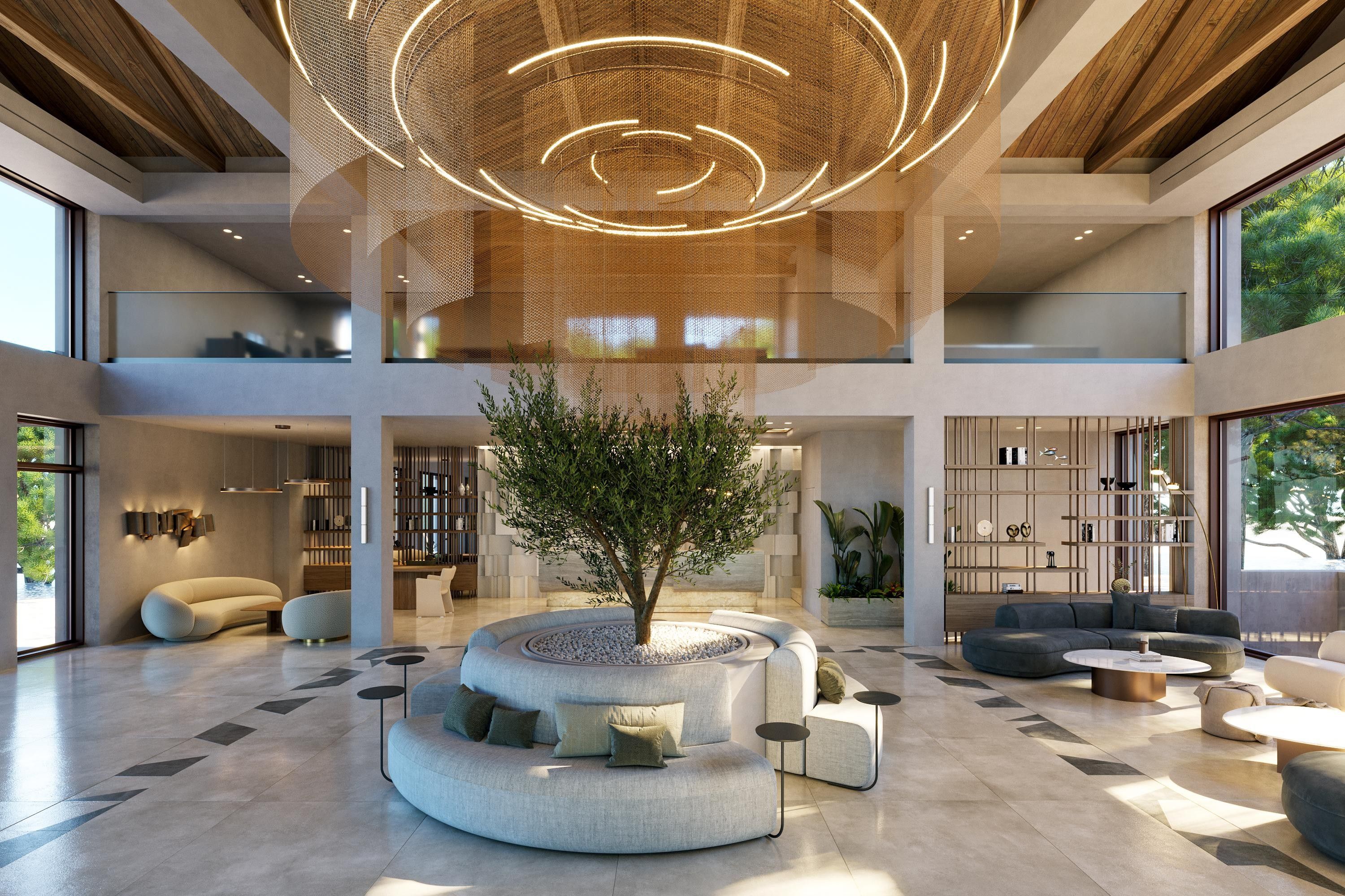 Eine geräumige Lobby mit einer zentralen Sitzecke, einem großen Baum und einem modernen Deckenstil.