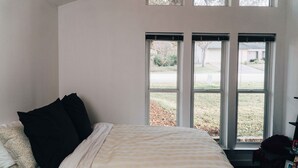 A bedroom with a bed, two windows, and a view of the outside. - SXSW House near iconic Barton Springs (Austin)