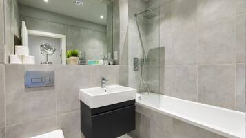 Bathtub, hair dryer, towels, soap