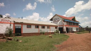A two-story building with a sign indicating accommodation availability. - Mumbi Rose Guest House (Thika)