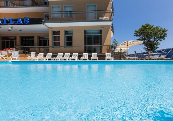 Seasonal outdoor pool, open 9:30 AM to 7:00 PM, pool umbrellas