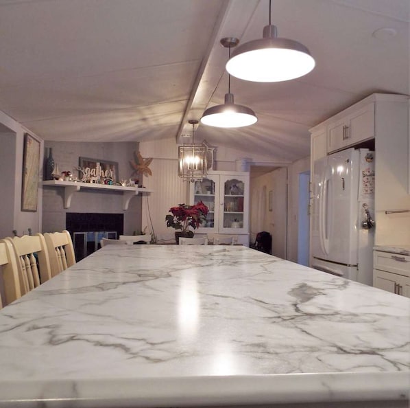 Enjoy cooking in this well-equipped kitchen with a large island, oven, and refrigerator.