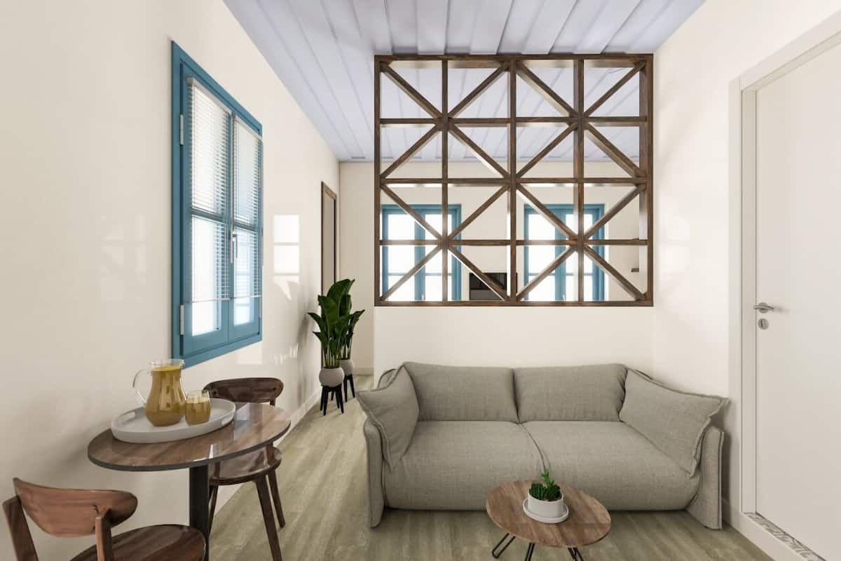 A modern living room with a sofa, a coffee table, and a dining area with a table and chairs.