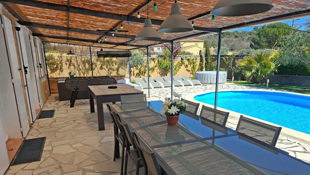 An outdoor patio with a pool, stone flooring, and a table with chairs. - Villa with pool near Lake Ste Croix (Régusse)