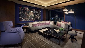 A modern living room with a sectional sofa, a coffee table, and a floor lamp.