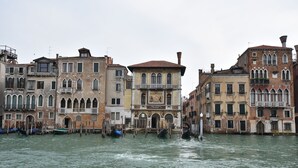 A canal with historic buildings and gondolas.