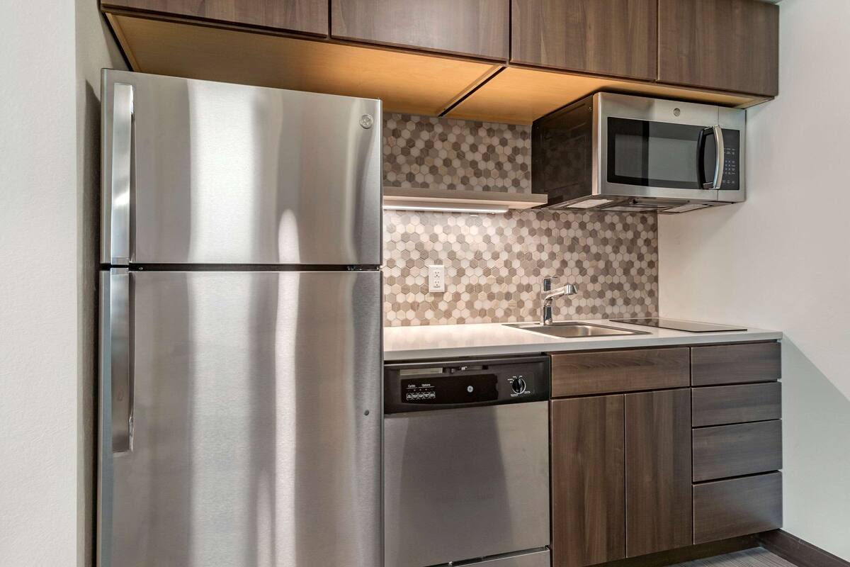A modern kitchen with stainless steel appliances, a microwave, and a dishwasher.