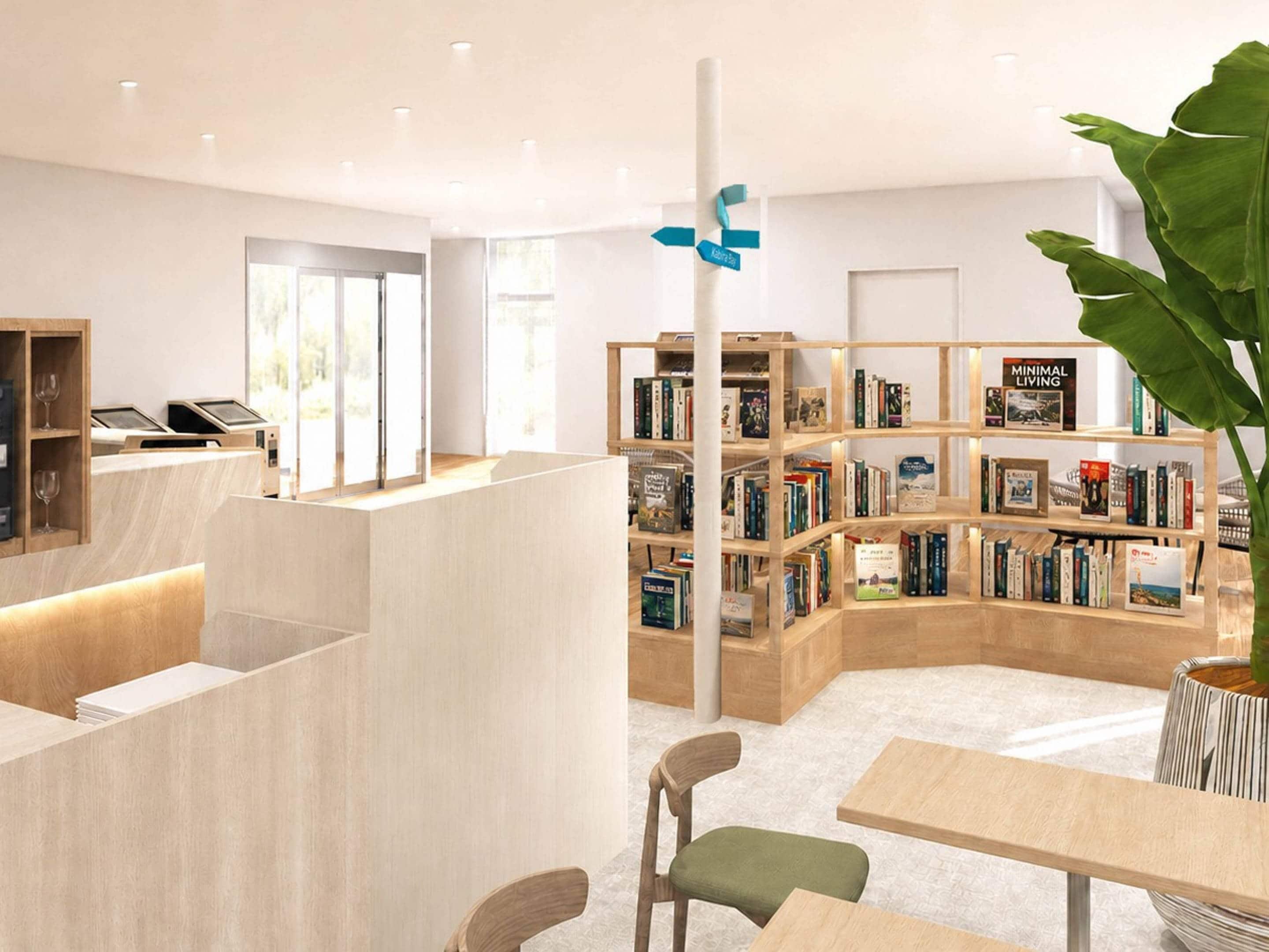 A modern library with bookshelves, a checkout counter, and seating areas.