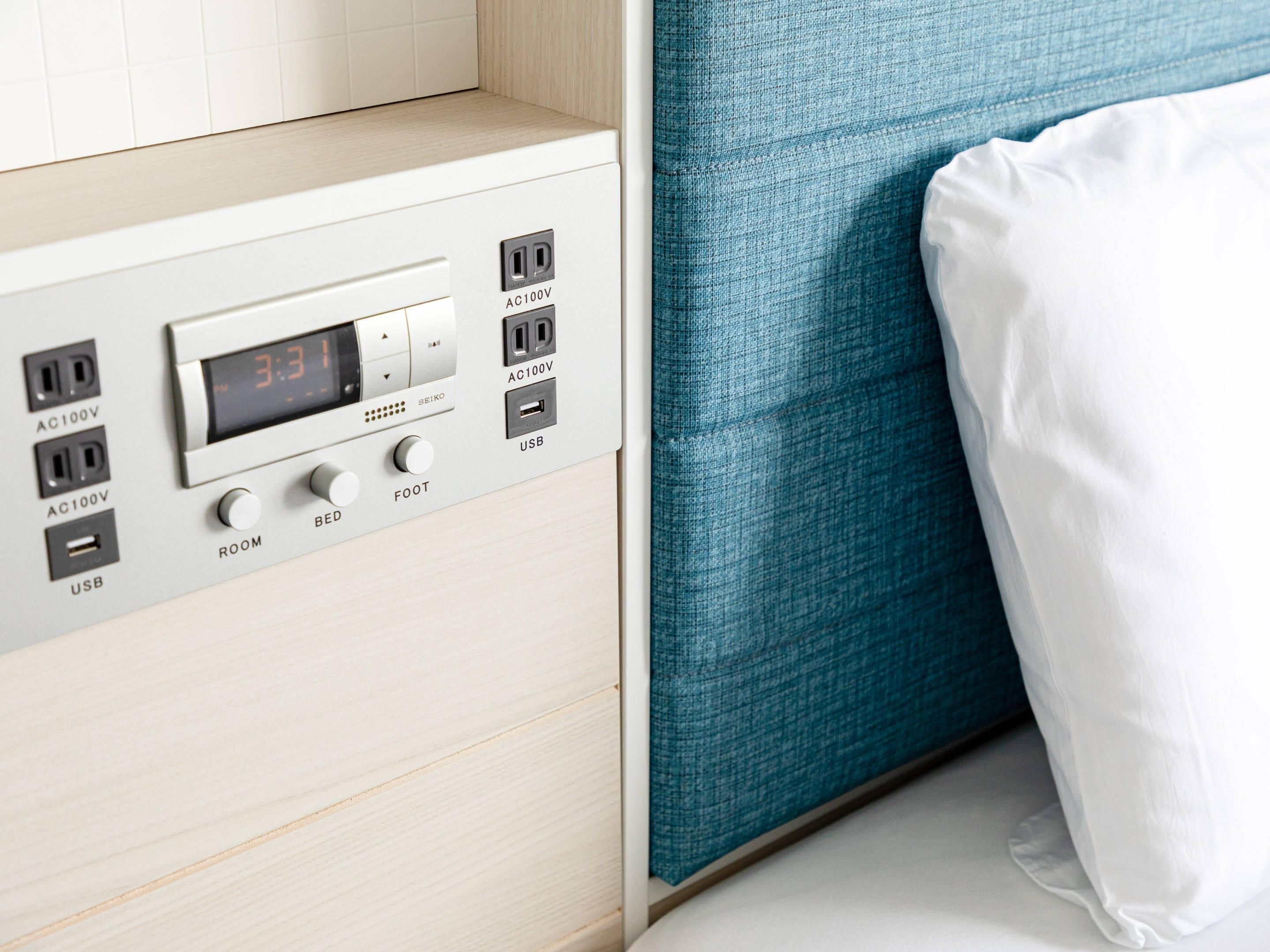 A control panel with AC100V outlets, a digital clock, USB ports, and a foot switch labeled ROOM, BED, and FOOT.