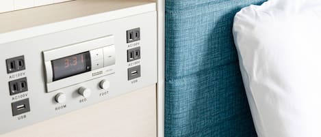A control panel with AC100V outlets, a digital clock, USB ports, and a foot switch labeled ROOM, BED, and FOOT.