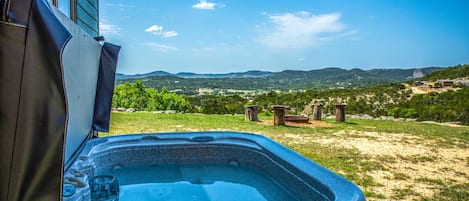 Un jacuzzi con vista despejada a un paisaje montañoso al fondo.