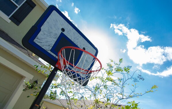 A basketball hoop attached to a building with a clear blue sky in the background. - Trafalgar Retreat by Orlando Short Term (Kissimmee)
