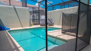 An indoor swimming pool with a view of a building in the background. - Gatsby Storey by Orlando Short Term (Kissimmee)