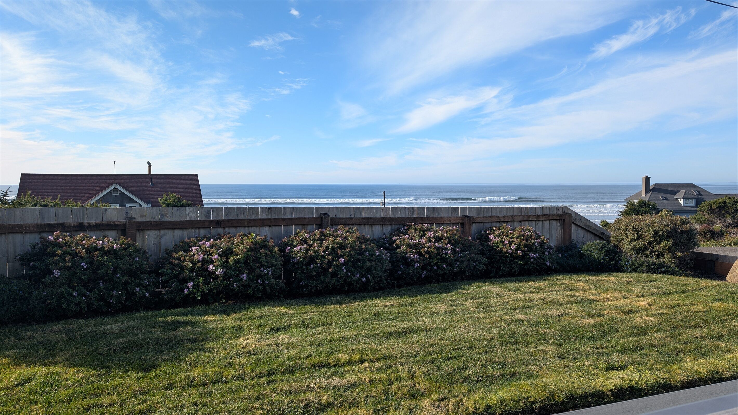 grassy area in front of deck just partially fenced