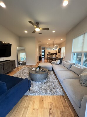 Relax in a spacious living area with a comfortable sofa, coffee table, and flat-screen TV.