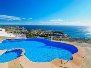 A swimming pool with a view of the ocean and a coastal town. - Pueblo Panorama by Interhome (Moraira)