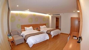 A hotel room with two beds, a seating area, and a small table. - Greentree Inn Tongxiang Chongfuzhen World Fur Cent (Jiaxing)