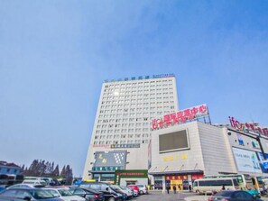 A multi-story hotel with a prominent sign for a medical center. - Greentree Inn Tongxiang Chongfuzhen World Fur Cent (Jiaxing)
