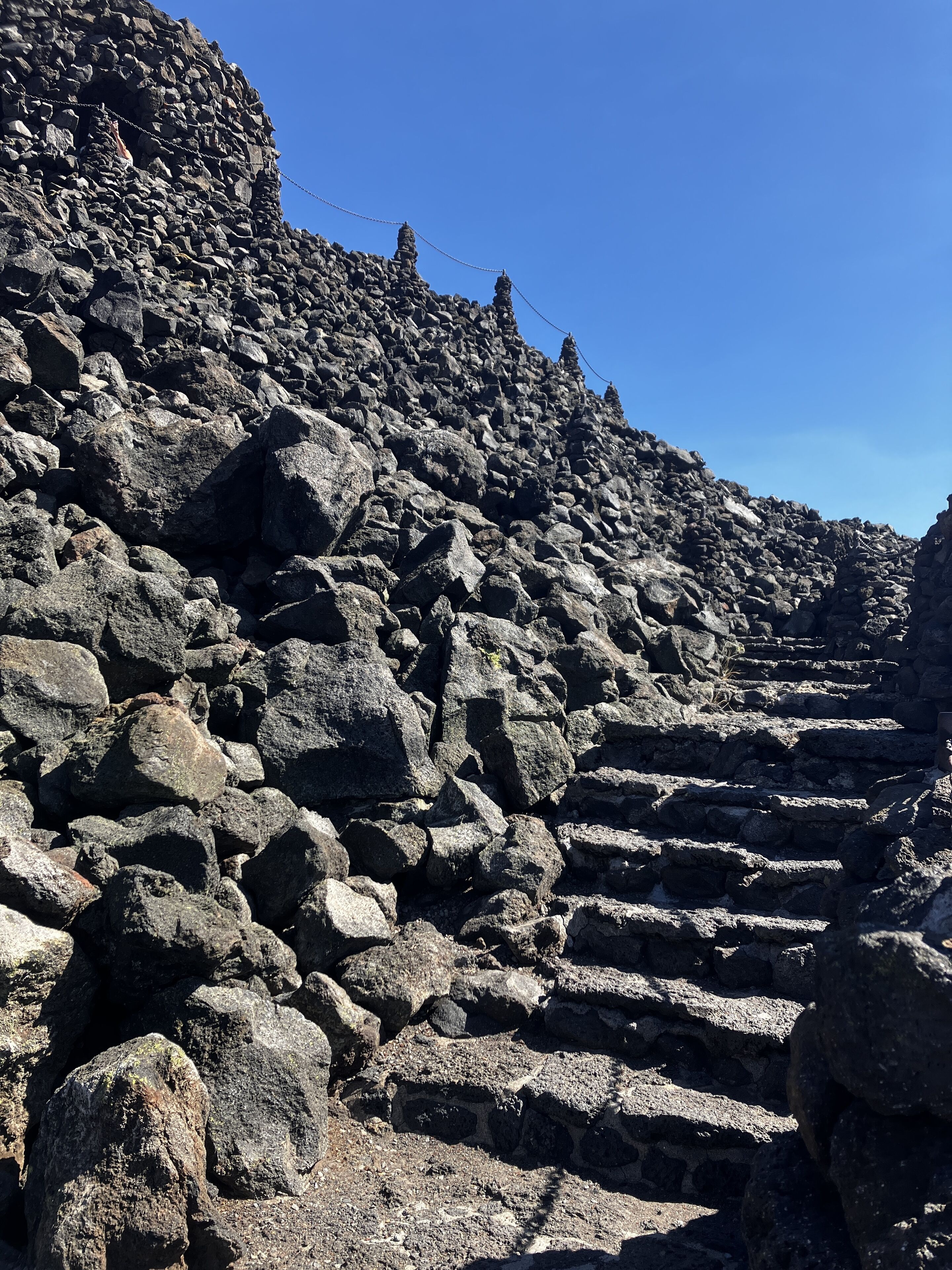 A rocky staircase leading up a steep, uneven terrain.
