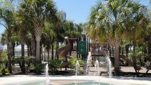 A water feature with a spiral design, surrounded by palm trees and a playground with slides. - Oakwater, 3 bedrooms - The nearest resort from Disney! (Kissimmee)