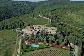 A large estate with multiple buildings, surrounded by lush vineyards and terraced fields. - Farmhouse Borgo Castelvecchi (Radda in Chianti)