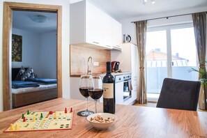 Cozy living space with a dining area, kitchenette, and comfortable bed.