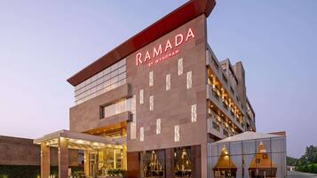 A modern building with the name 'RAMADA BY WYNDHAM' prominently displayed.