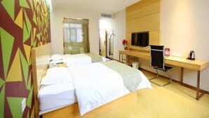A hotel room with two beds, a desk, a TV, and a mirror. - Vaticawuxi Huishan District Western Shengan Road Baile Square Hotel (Wuxi)