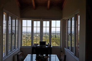 A room with large windows offering a view of a landscape. - Villa with panoramic view (CORFU)