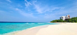 On the beach, white sand, beach umbrellas, beach towels