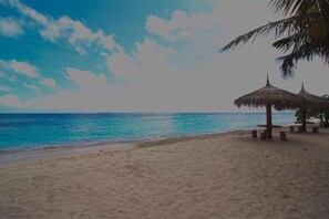 On the beach, white sand, beach umbrellas, beach towels