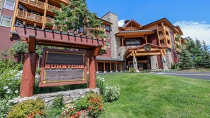 A large, multi-story building with a prominent sign reading "Sunstone." - Sunstone 209 Ski-In Ski-Out, Gorgeous Mountain Views, Heated Pool Jacuzzi by RedAwning (Mammoth Lakes)