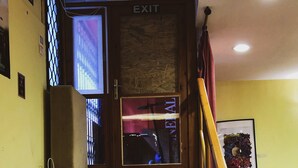 A staircase leading to an exit with a sign above it. - Former Pub 3 for Stag do  men's cave  bachelor, bachelorette party for sleepers (IX. kerület)